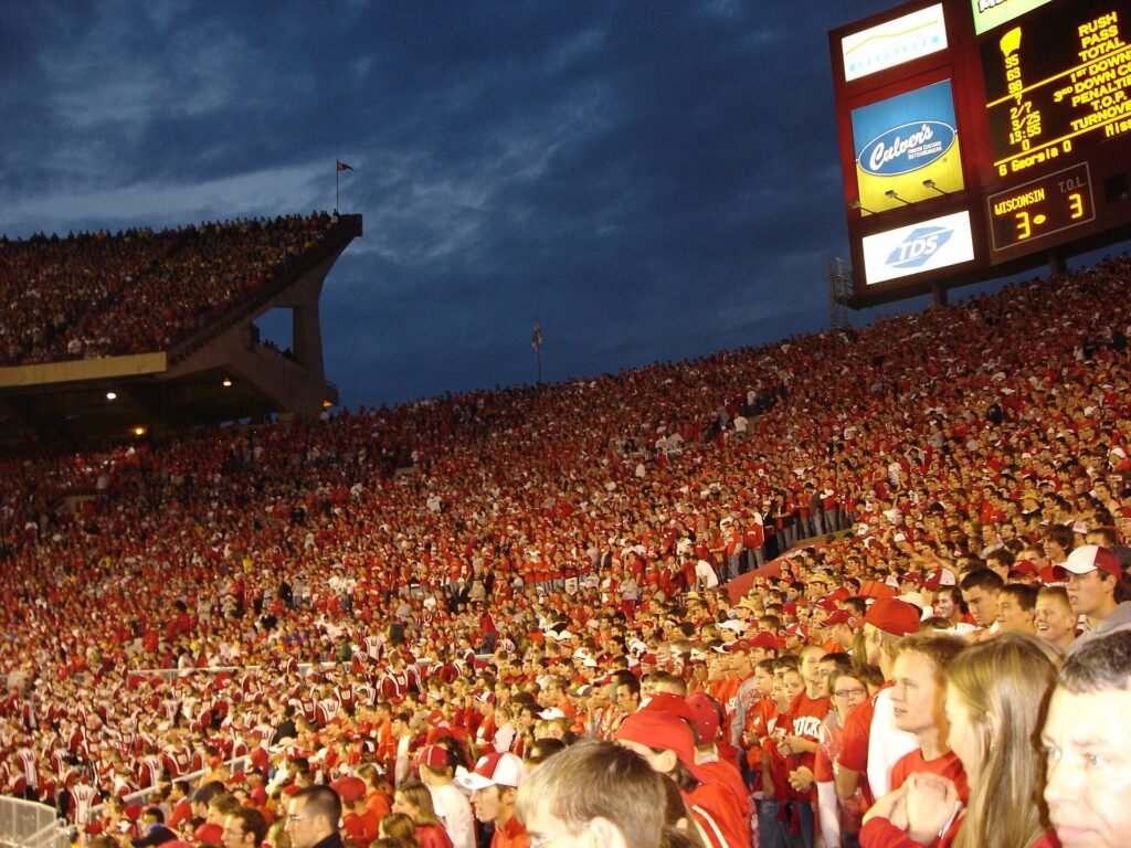 Packed college football crowd at dusk